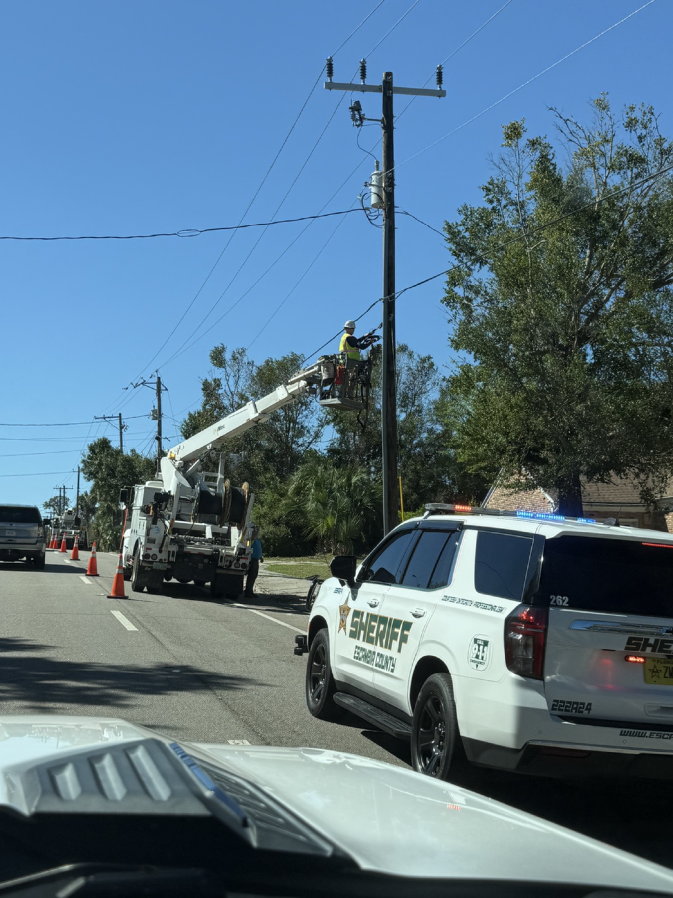 A utility lineman working during local power restoration